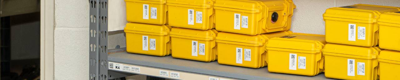 Yellow cases stacked on a storage shelf